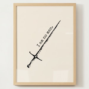 May include: A black and white print of a sword with the text "I am no man." in a light brown frame.