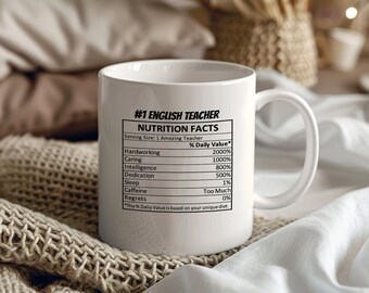 May include: White ceramic mug with a black graphic that reads "#1 English Teacher Nutrition Facts Serving Size: 1 Amazing Teacher Hardworking 2000% Caring 1000% Intelligence 800% Dedication 500% Sleep 1% Caffeine Too Much Regrets 0% *The % Daily Value is based on your unique diet."