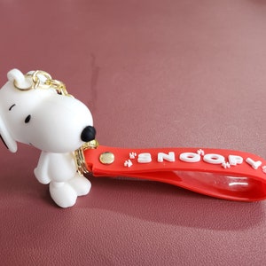 Charming Snoopy Keychain – White Snoopy Figure With Red Hand Strap and ...
