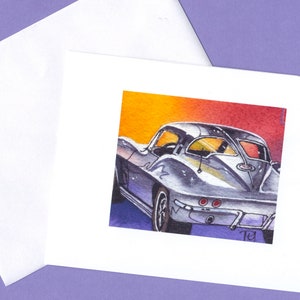 May include: A watercolor painting of a silver Corvette with a red, orange, and yellow sunset background. The car is facing away from the viewer and the rear window is visible. The car has a black interior and a black stripe running along the side. The painting is signed "71" in the bottom right corner.