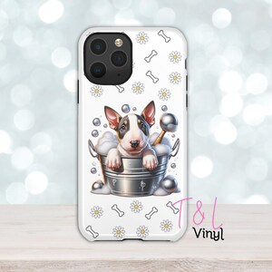 May include: White iPhone case with a white and black bull terrier puppy in a bucket of bubbles. The case has a white daisy and bone pattern. The text "T&L Vinyl" is in the bottom right corner.