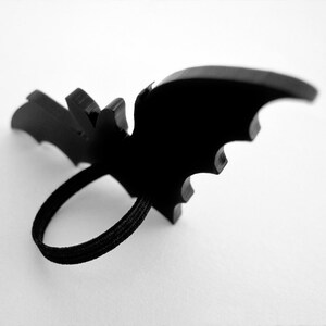 Back view of bat ring showing black elastic band setting – flexible and adjustable Halloween costume accessory.