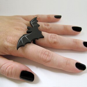 Side angle view of Vampire Bat Ring on hand – bold Halloween bat jewelry spanning three fingers.