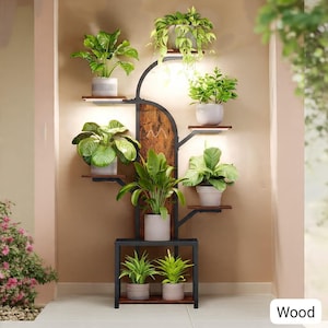 May include: A multi-tiered plant stand with a black metal frame and wooden shelves. The stand features a tree-like design with multiple levels holding various potted green plants. The word "Wood" is visible in the bottom right corner.