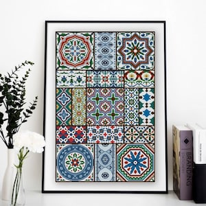 May include: Framed artwork featuring a mosaic of colorful, geometric tile patterns. The design incorporates various shapes and colors, including blue, red, green, and yellow. The artwork is displayed in a black frame, adding a touch of elegance to the decorative piece.
