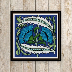 May include: A cross-stitch pattern featuring a stylized floral design with blue flowers and white feathers on a dark blue background.