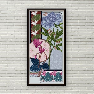 May include: A framed art print featuring a stylized floral design with pink, blue, and green flowers. The print is set against a light blue background and has a black frame.
