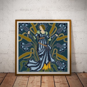 May include: A cross-stitch pattern depicting a woman in a blue dress standing in a field of blue flowers and tall grasses. The background is a dark blue colour.