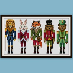 May include: A framed print featuring five pixelated animal nutcrackers: a lion, rabbit, fox, owl, and bear. Each figure is dressed in a military-style uniform with gold and jewel-toned accents. The artwork is set against a white background.