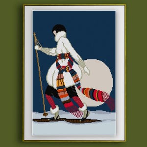 May include: Cross-stitch art of a skier in a white outfit with a colorful scarf and red socks. The skier is on skis with poles, set against a blue background with a large, off-white circle. The artwork is framed.