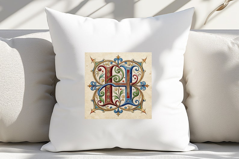 May include: White pillow with a decorative letter H in a colorful, ornate, medieval style. The letter is surrounded by a gold, red, blue, and green floral design.