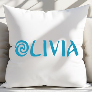 May include: A white pillow with a blue swirl design and the name 'OLIVIA' written in blue cursive font.