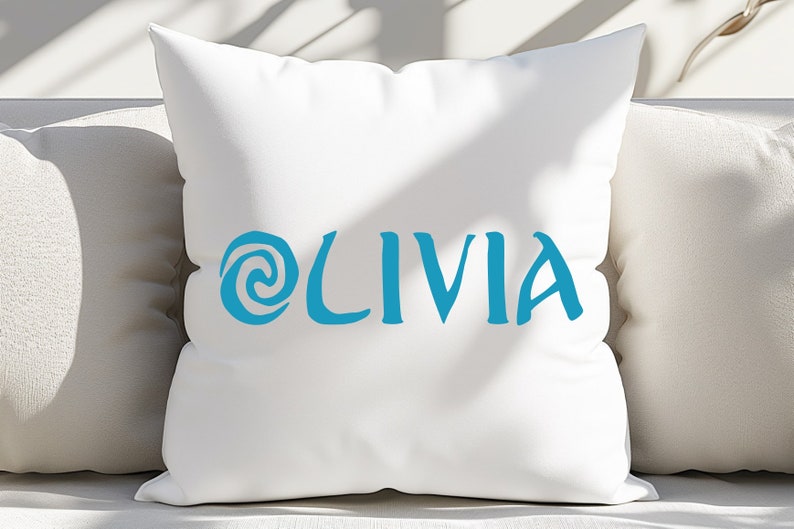 May include: A white pillow with a blue swirl design and the name 'OLIVIA' written in blue cursive font.