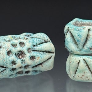 May include: A white ceramic mug with a black handle and the text "But First, Coffee" in a bold, black font. The mug is set against a blurred background, highlighting its clean design.