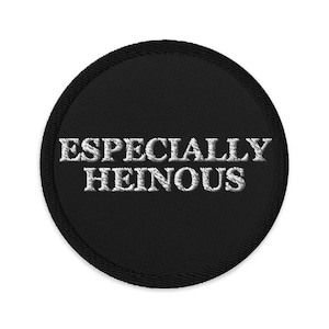 Puede incluir: Un parche redondo negro con texto bordado en blanco que dice "ESPECIALLY HEINOUS".