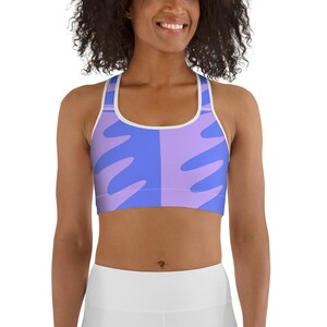 May include: A purple and blue sports bra with a white trim and a geometric pattern. The bra is made of a stretchy, breathable fabric and is perfect for working out or running errands.