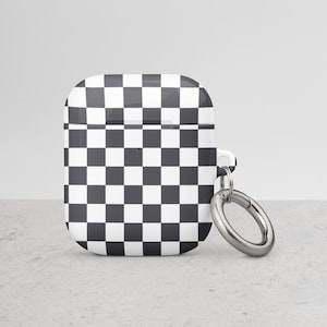 May include: A black and white checkered Airpods case with a silver metal keychain.