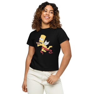 May include: Black t-shirt with a graphic of Bart Simpson as a cupid with wings and a heart-shaped arrow. The graphic is in yellow, red, and brown.