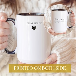 May include: White ceramic mug with a black interior and handle. The mug has the text "CHAPTER 70" and a black heart on one side, and the name "Barbara" and copyright information on the other. The words "PRINTED ON BOTH SIDE" are at the bottom.