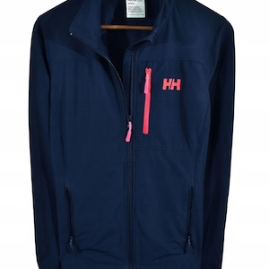 May include: Navy blue zip-up jacket with a bright pink zipper and the letters "HH" in pink on the chest. The jacket has two side pockets and a high collar. The jacket is hanging on a wooden hanger.