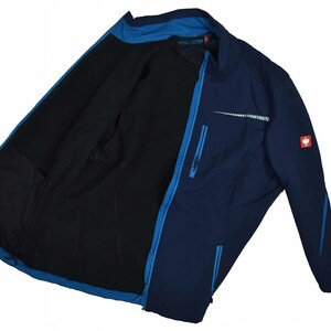 May include: Navy blue jacket with a black interior. The jacket features a full-length zipper, multiple pockets, and a reflective stripe across the chest. A small red and white logo is visible on the sleeve.