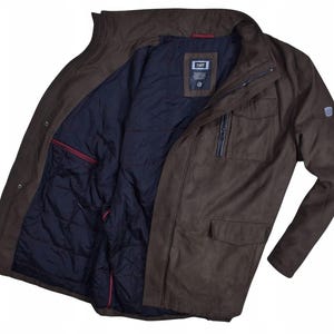 May include: A brown jacket with a dark blue quilted lining. The jacket has a zipper closure, multiple pockets, and a small logo on the sleeve. The collar is a stand-up style.