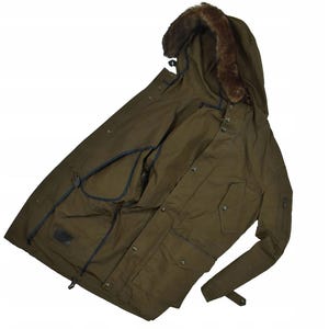 May include: Olive green parka with a fur-lined hood. The jacket features multiple pockets, a button-up front, and a drawstring waist. The sleeves have adjustable cuffs. The parka is designed for cold weather.