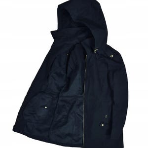 May include: A navy blue hooded jacket with a full-length zipper and gold-colored hardware. The jacket has a high collar and two front pockets. The hood is attached and the jacket is open, revealing the interior lining.