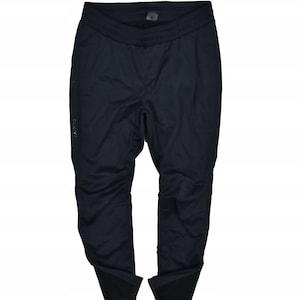 May include: Black athletic pants with a drawstring waistband and a small logo on the left leg. The pants have a straight leg design and zippered ankles. These pants are suitable for running, training, or other athletic activities.