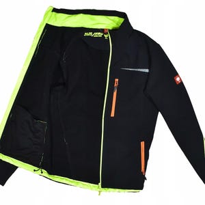 May include: Black jacket with neon green accents on the inside lining, collar, and zipper trim. Features orange zippers and a reflective stripe on the chest. Includes a small logo patch on the upper right sleeve. The jacket has a full-length zipper and two front pockets.