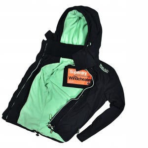 May include: Black hooded jacket with a mint green interior lining. The jacket features a full zipper, drawstrings, and the text "Superdry Professional Windcheater" on a tag. The jacket has a ribbed collar and cuffs.