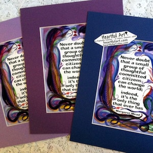May include: Three framed prints with a colorful abstract background and a quote by Margaret Mead: "Never doubt that a small group of thoughtful, committed citizens can change the world; indeed, it's the only thing that ever has."