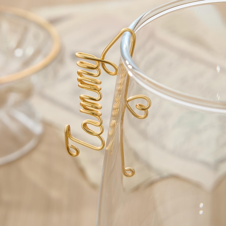 May include: Gold wire mug charm with the word "Tammy" and a heart.