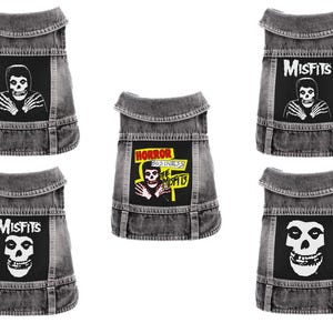 May include: Five gray denim dog vests with black patches featuring the Misfits band logo and skull imagery. One vest has the text "HORROR BUSINESS" and the Misfits skull logo.