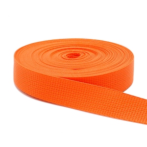 May include: A roll of bright orange webbing, a type of heavy-duty fabric used for straps, belts, and other applications.