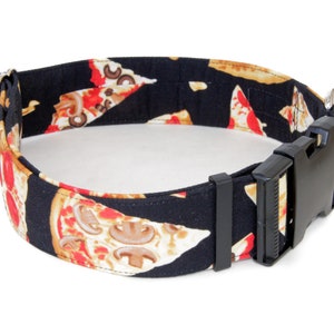 May include: Black dog collar with a pizza slice pattern. The collar has a black plastic buckle.
