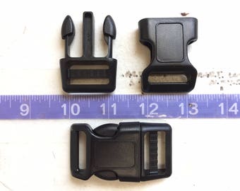 May include: Three black plastic side release buckles. The buckles are different sizes. The smallest buckle is 2.5 cm wide, the middle buckle is 3.8 cm wide, and the largest buckle is 5 cm wide.
