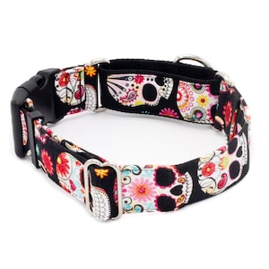 May include: A black dog collar with a colorful sugar skull pattern. The collar is made of durable nylon and features a silver buckle and D-ring.