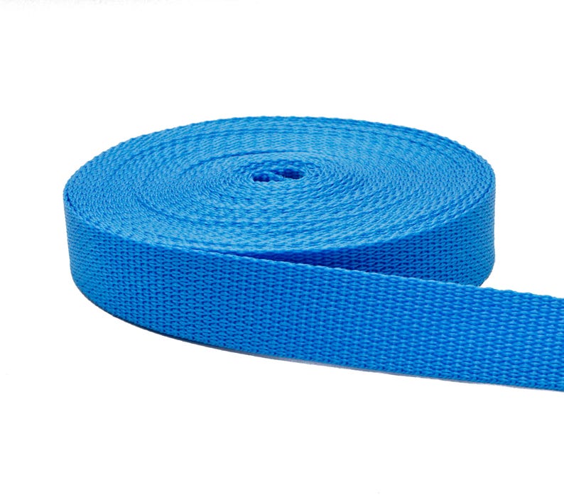 May include: A roll of bright blue nylon webbing, a type of strong, durable fabric often used for straps, belts, and other applications.