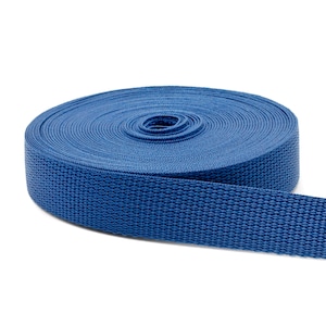 May include: A roll of blue webbing, a type of strong, woven fabric often used for straps and belts.