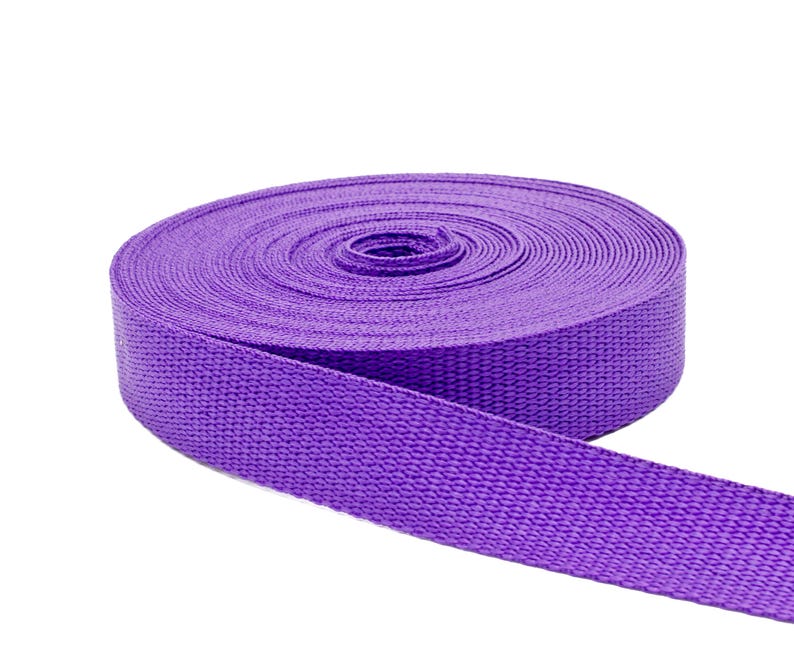 May include: A roll of purple webbing, a type of strong, woven fabric often used for straps and belts.