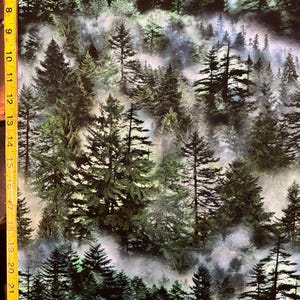 May include: A fabric with a forest scene featuring tall evergreen trees in varying shades of green and dark brown. Wisps of fog or mist create depth and a sense of atmosphere. The image is a repeating pattern.