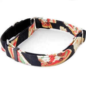 May include: A black and white dog collar with a pizza print. The collar is made of fabric and has a metal buckle.