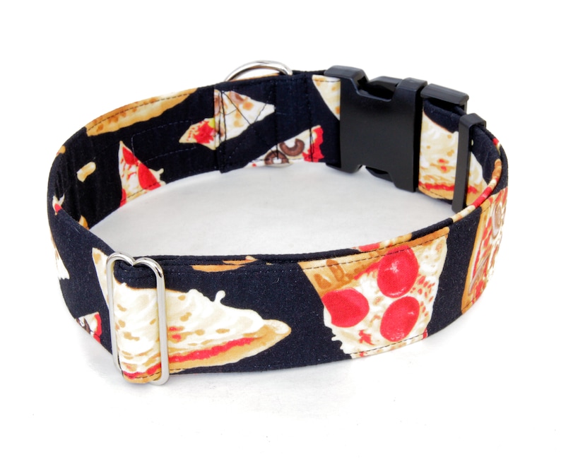 May include: Black dog collar with a pizza print. The collar has a silver buckle and a black plastic buckle.