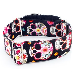 May include: Black dog collar with a colorful sugar skull pattern. The collar is made of durable fabric and has a silver buckle.