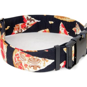 May include: A black dog collar with a pizza print. The collar has a black plastic buckle.