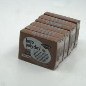 May include: Six brown packages of Kato Polyclay polymer clay are stacked on a white surface. Each package is rectangular and features a white label with the brand name and product information. The clay appears to be a medium brown color.