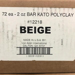 May include: A cardboard box with text that reads "72 ea - 2 oz BAR KATO POLYCLAY" and "BEIGE." The box also includes the text "MADE IN U.S.A. BY: Van Aken International DALTON, GA 30721" and a barcode.