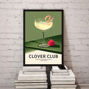May include: A vintage-style poster with a green background featuring a cocktail called the Clover Club. The cocktail is in a coupe glass with a lemon twist garnish and a raspberry. The text on the poster reads "Clover Club" and "Ingredients: Gin, Raspberry, Lemon, Lemon Juice."