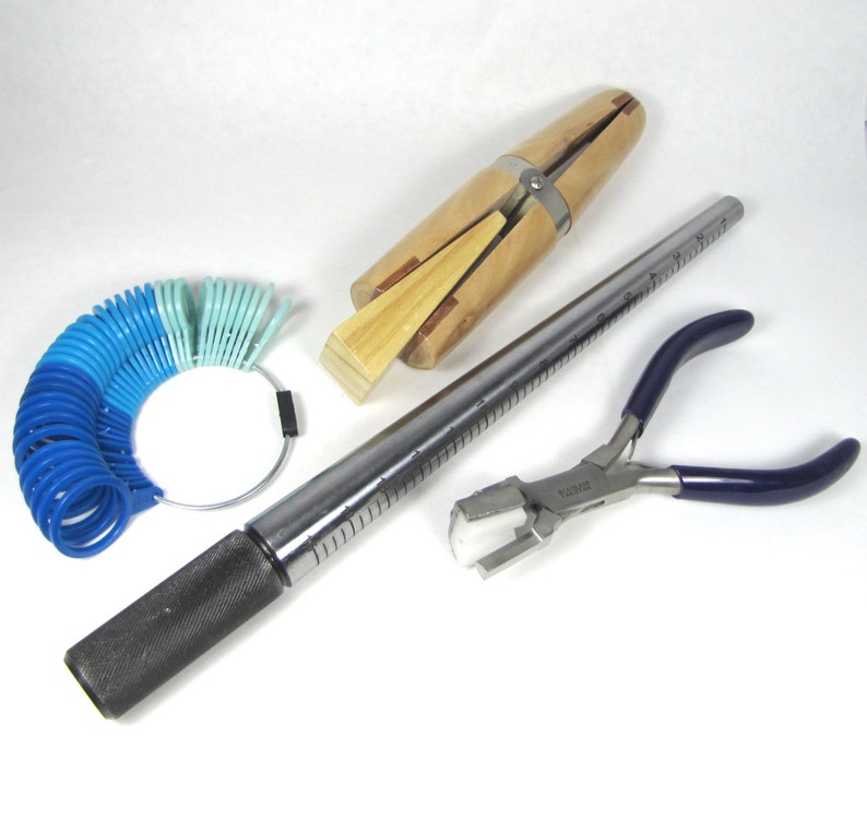 May include: A set of jewellery making tools including a ring sizer, a mandrel, a ring clamp, and a pair of pliers.
